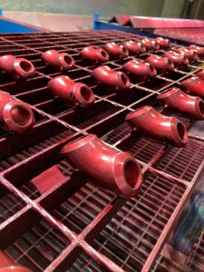 Red dye penetrant testing on pipe fittings