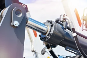 Hydraulic ram and cylinder used in weapons handling equipment